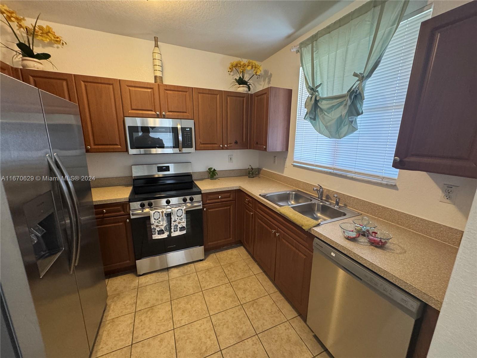 a kitchen with a sink a stove and refrigerator