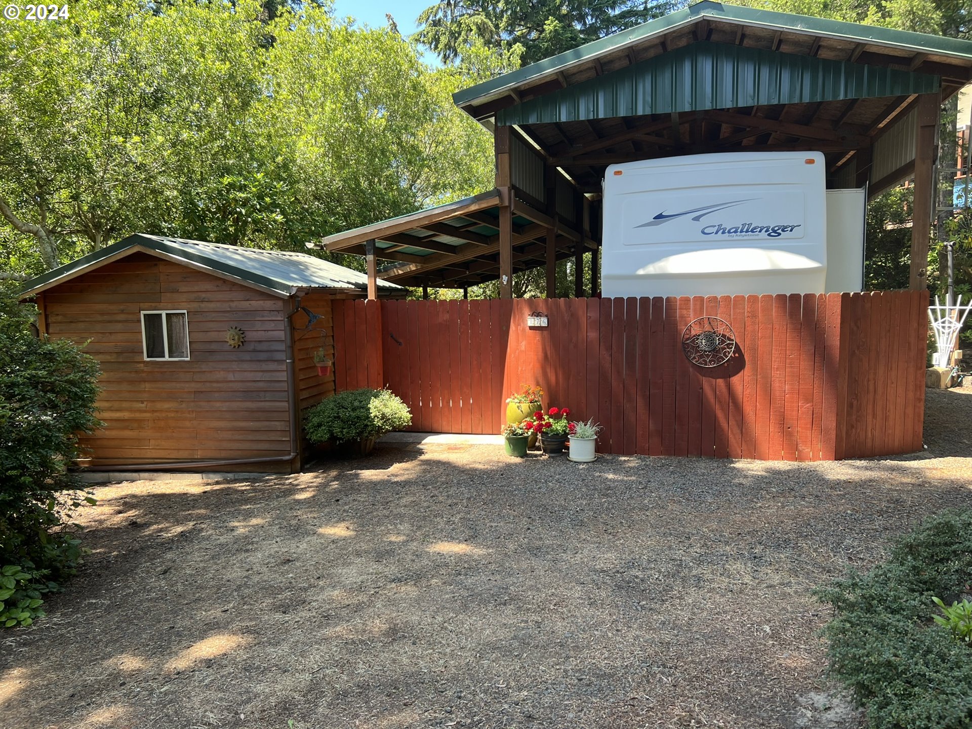 a view of a wooden house with a small yard