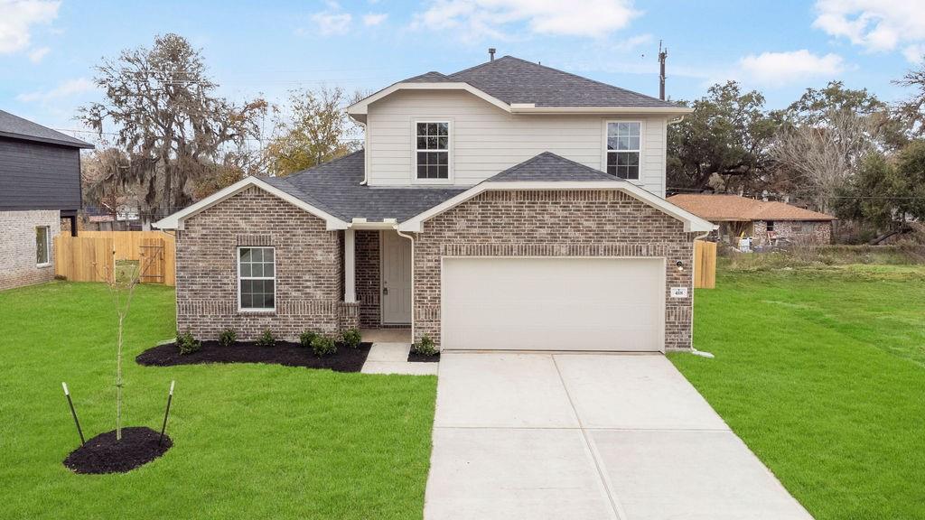 a front view of a house with a yard and garage