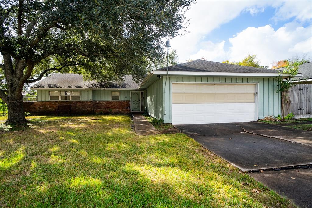 a front view of house with yard and trees around