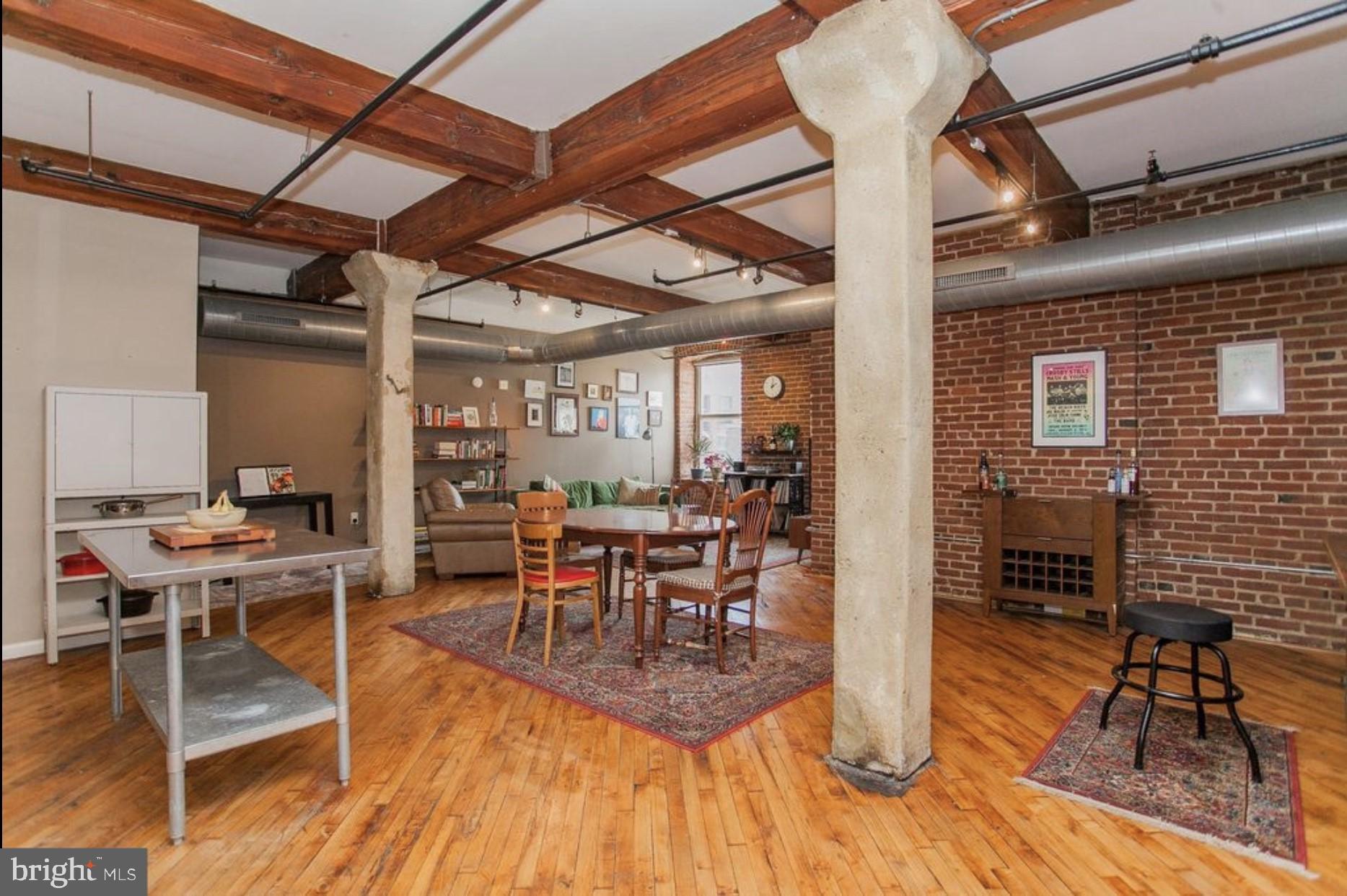 a dining room with furniture a chandelier and wooden floor