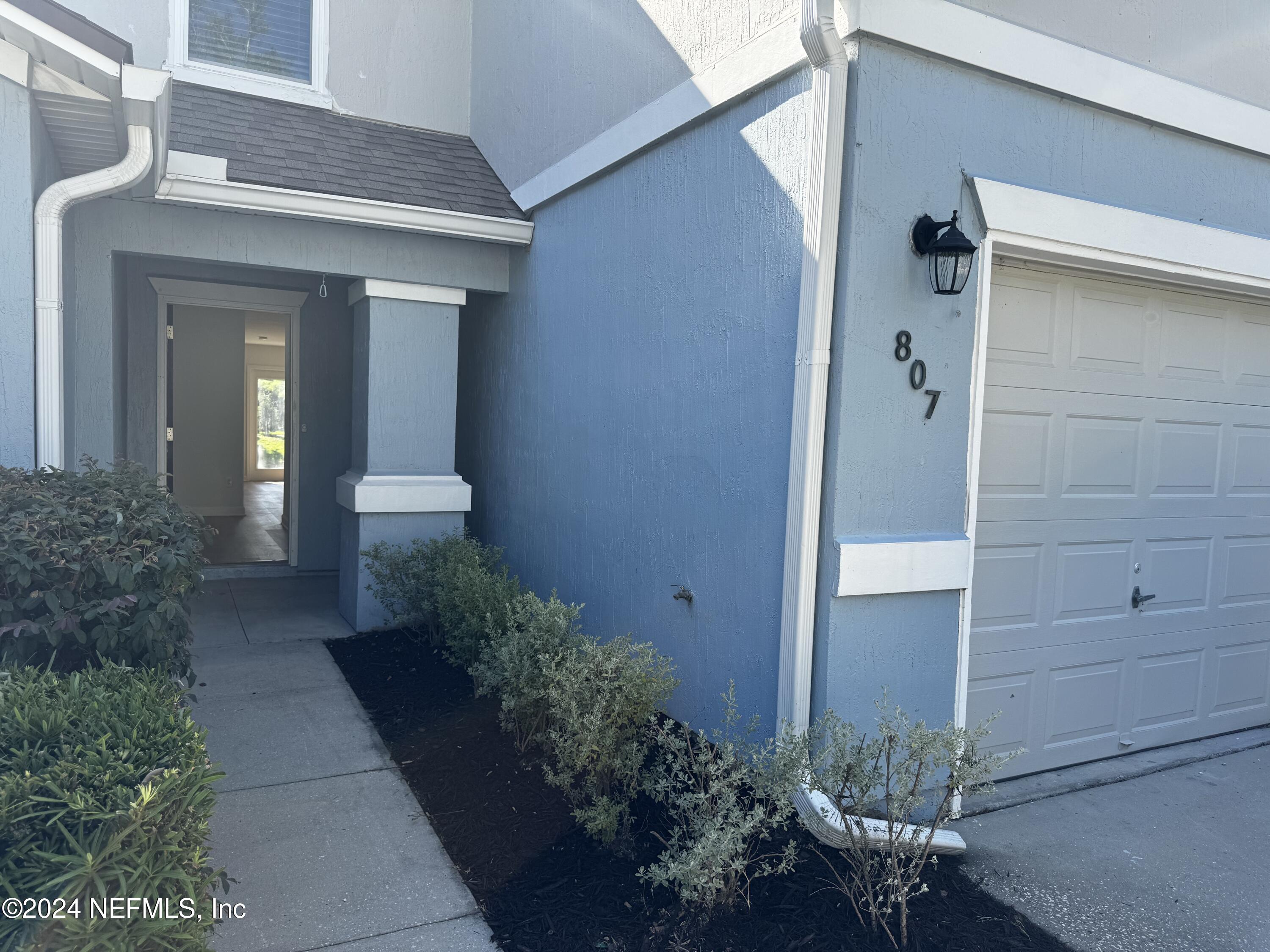 a view of a pathway besides a house