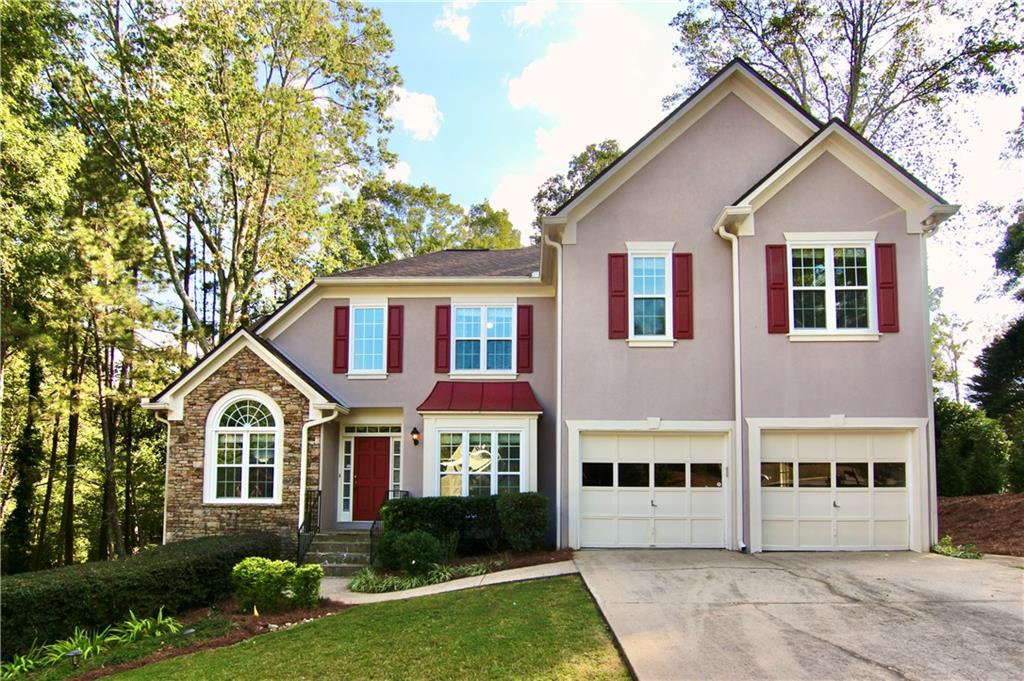 a front view of a house with a yard and garage