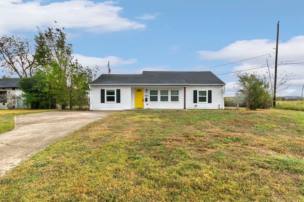 a front view of house with yard and trees around