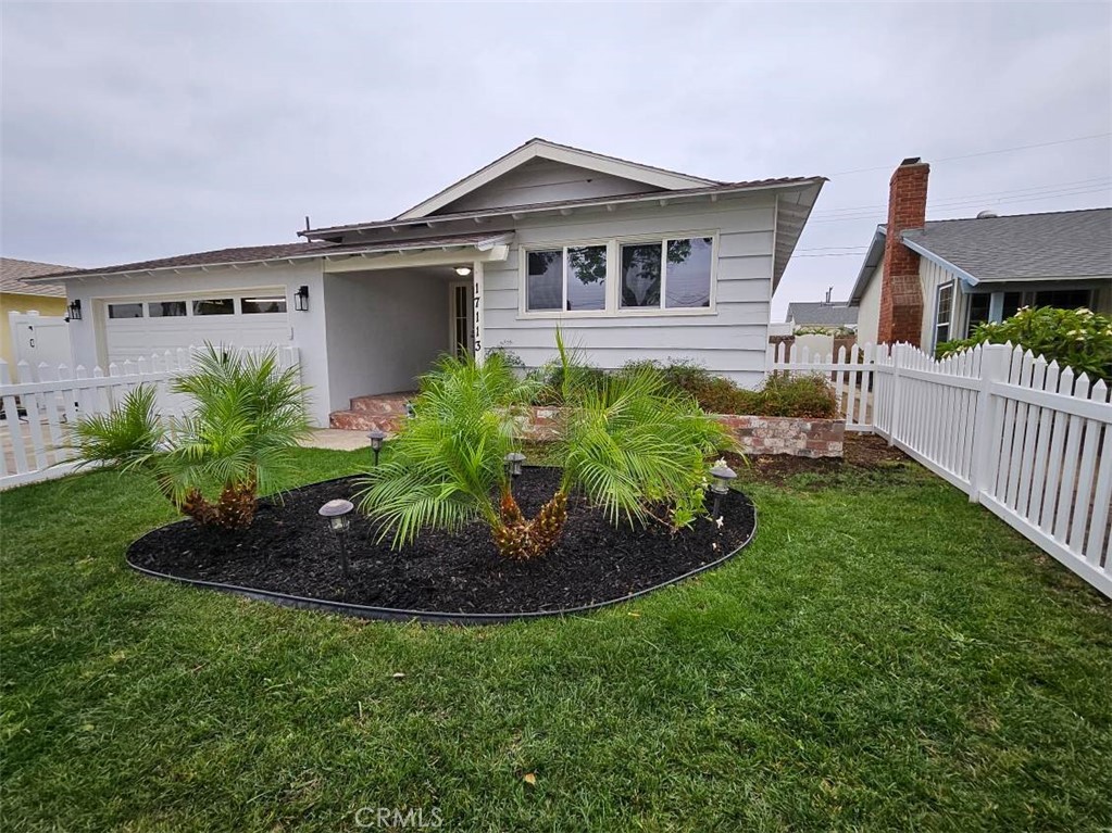 a front view of a house with a garden