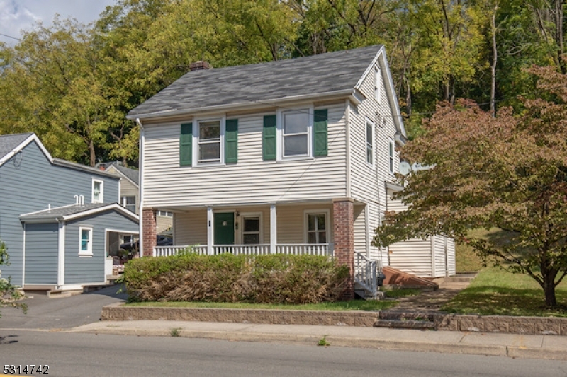 a house that has a tree in front of it