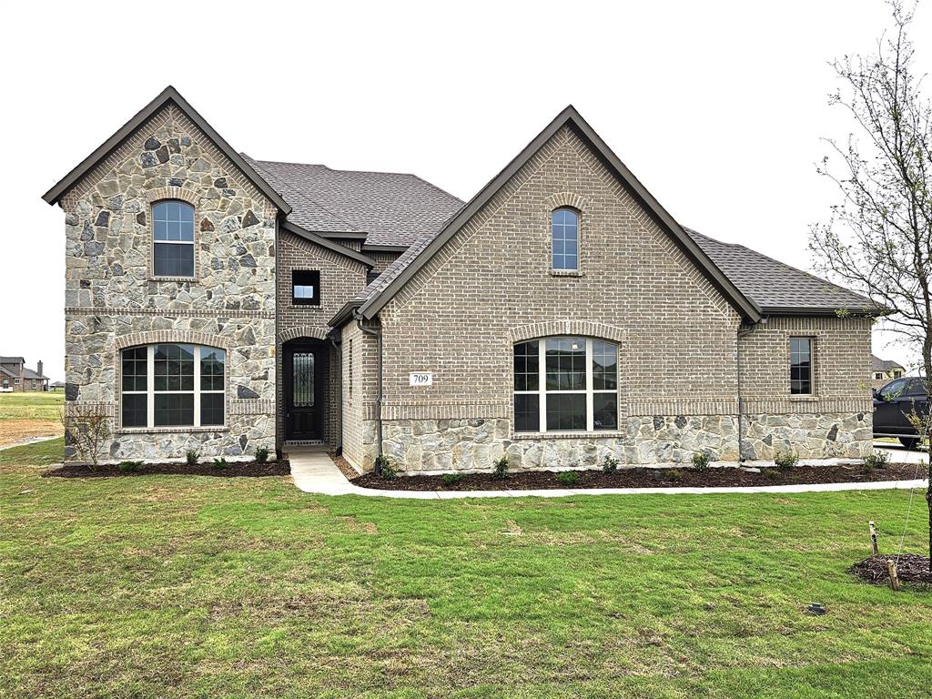 a front view of a house with a yard