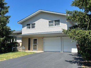 a front view of a house with garage