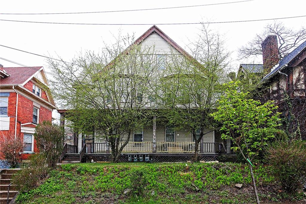 a front view of a house with a garden