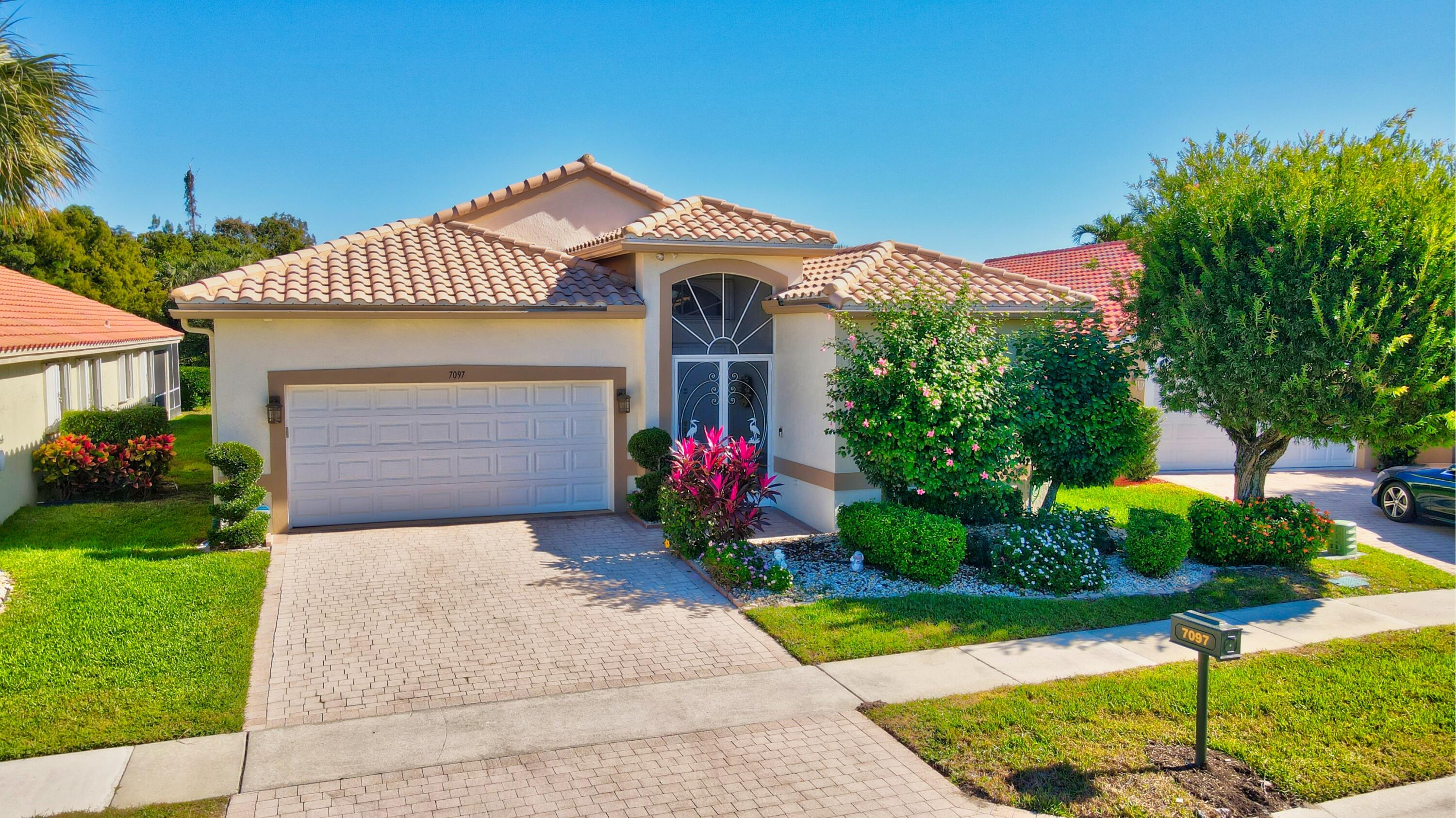 a front view of a house with a yard and a garage