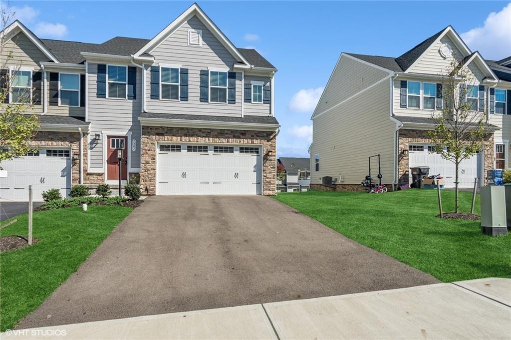 a front view of a house with a yard and garage