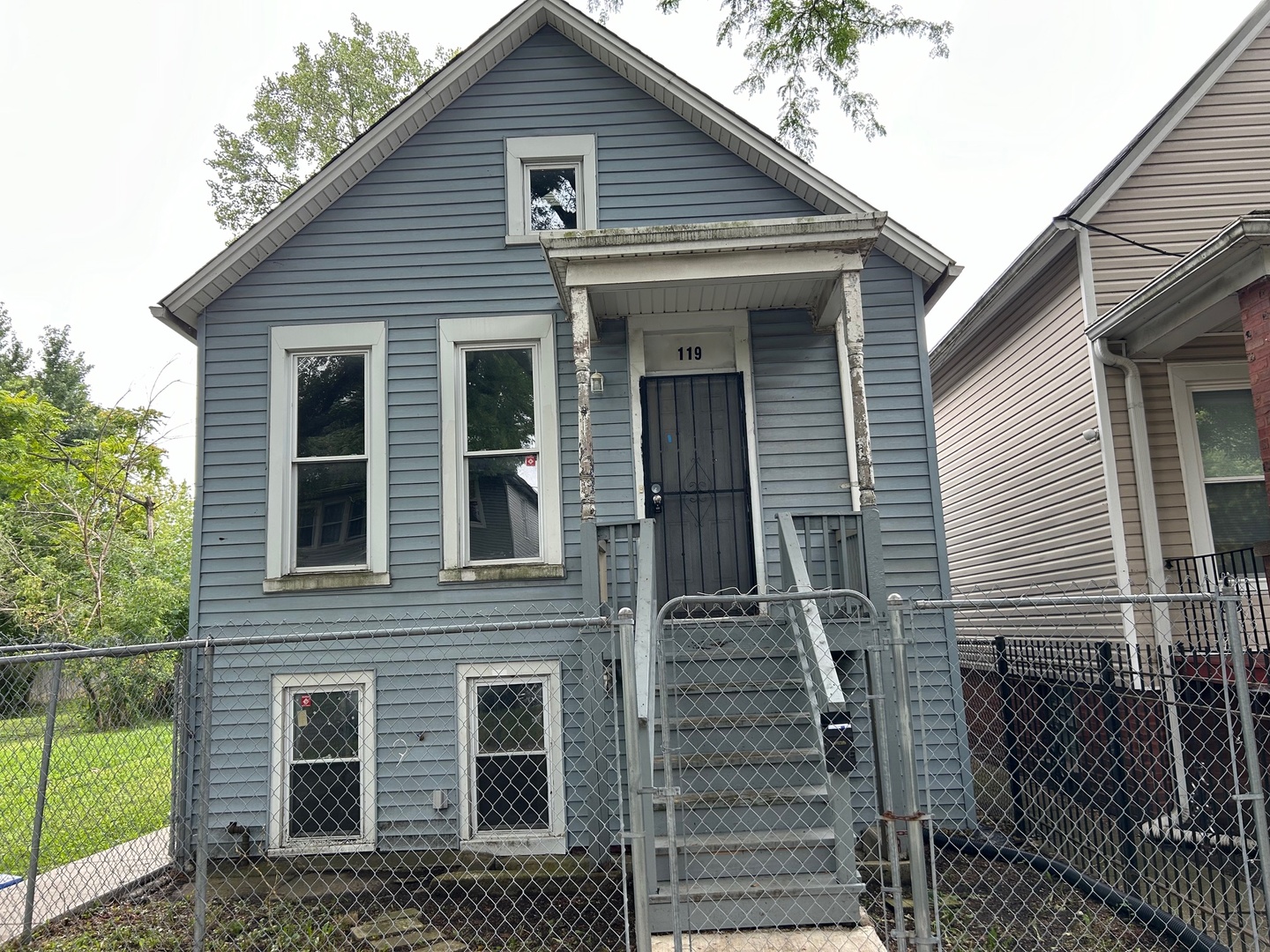 a view of a house with wooden fence and large windows