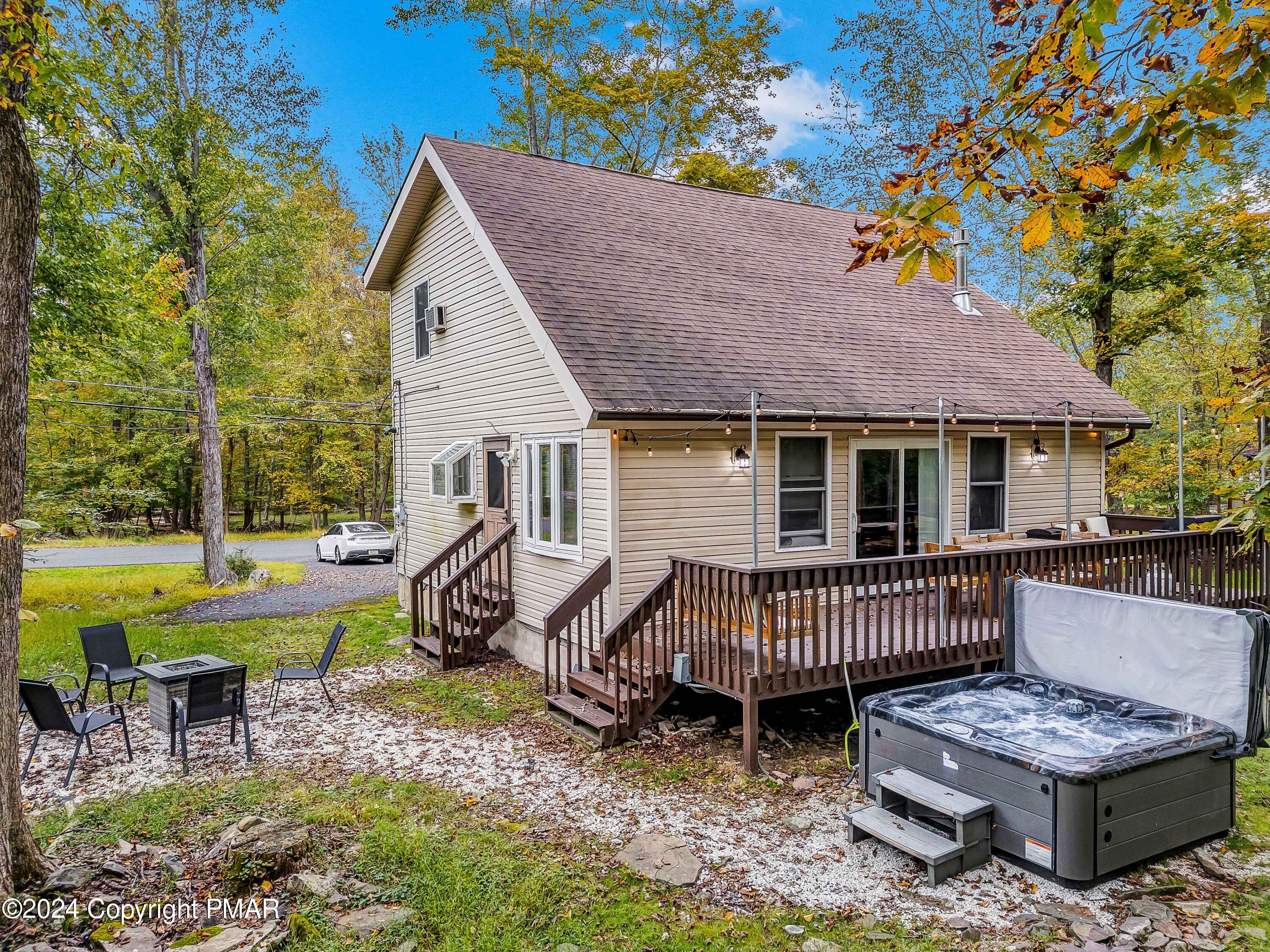 a view of a chairs and table in backyard of the house