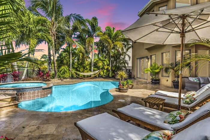 a view of a house with backyard and sitting area