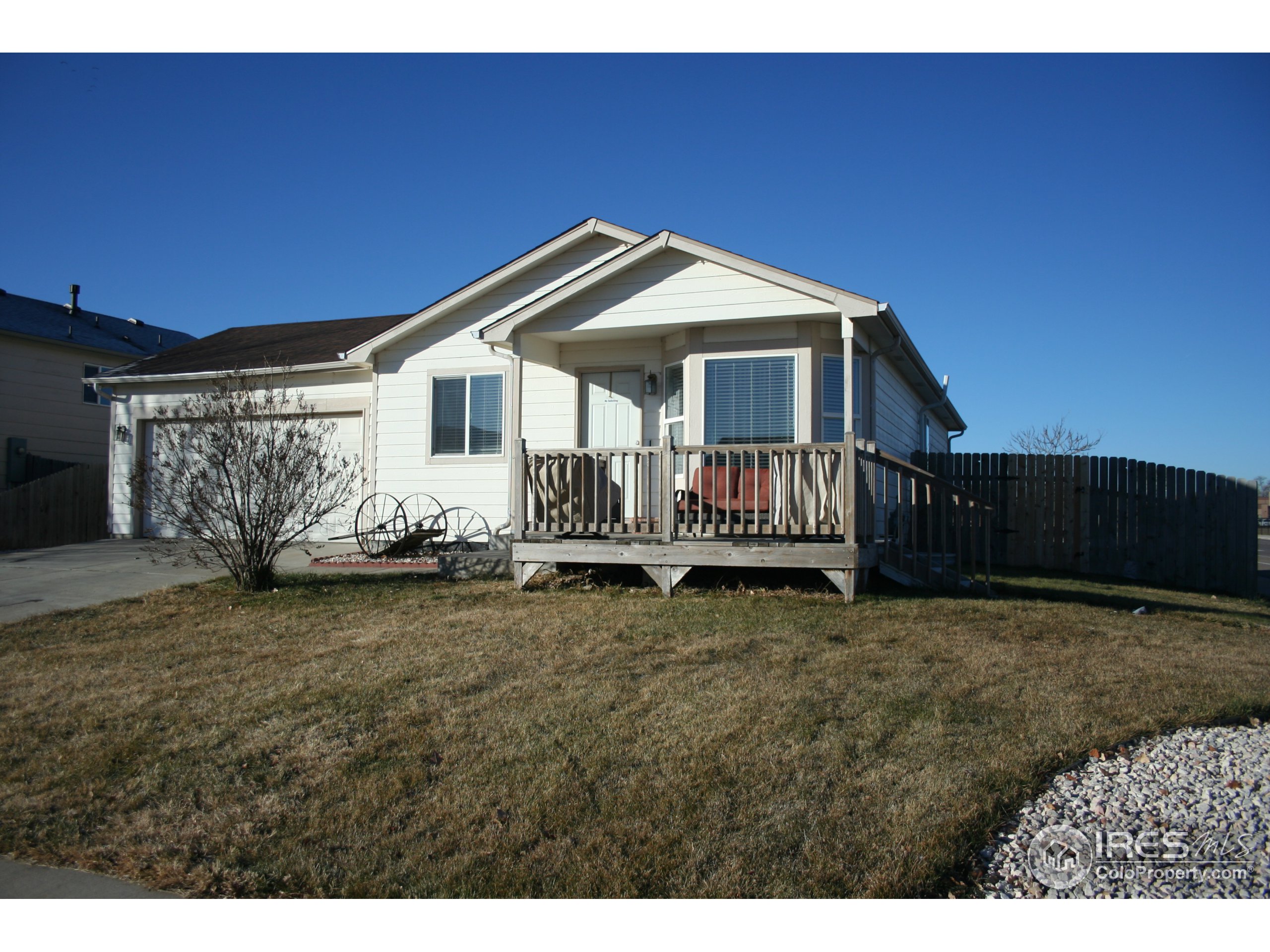 a view of a house with wooden fence