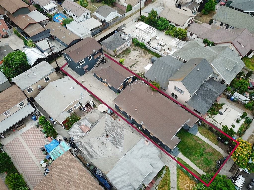 an aerial view of a house with a yard and lake view