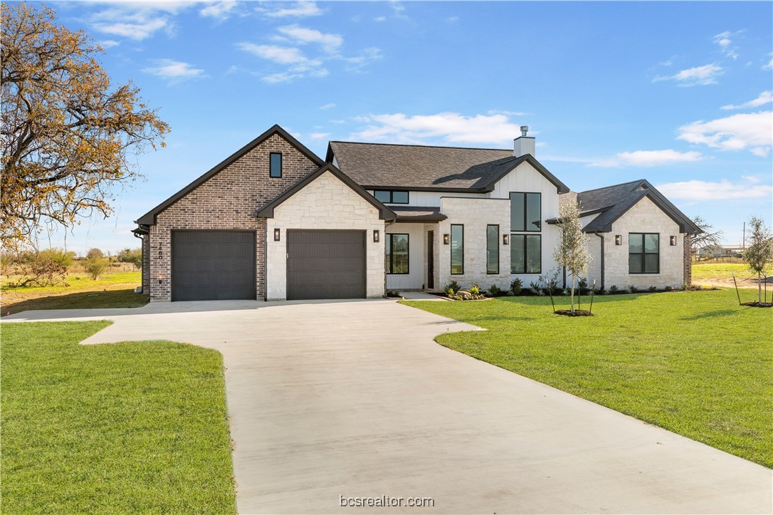 a front view of house with yard and green space