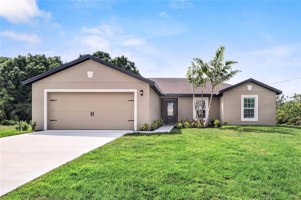 a front view of a house with a yard and garage