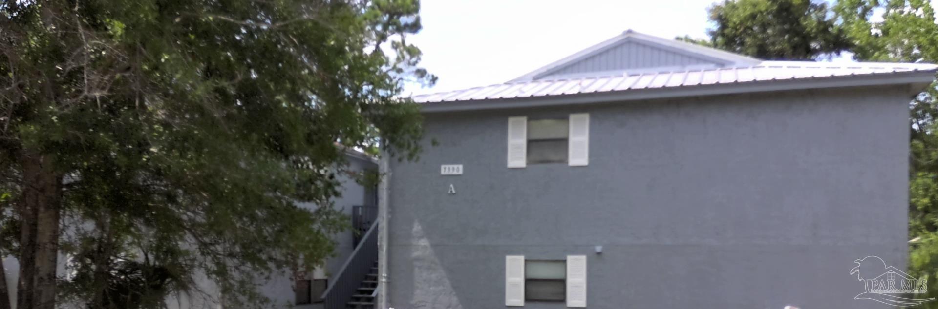 a view of a house with a tree