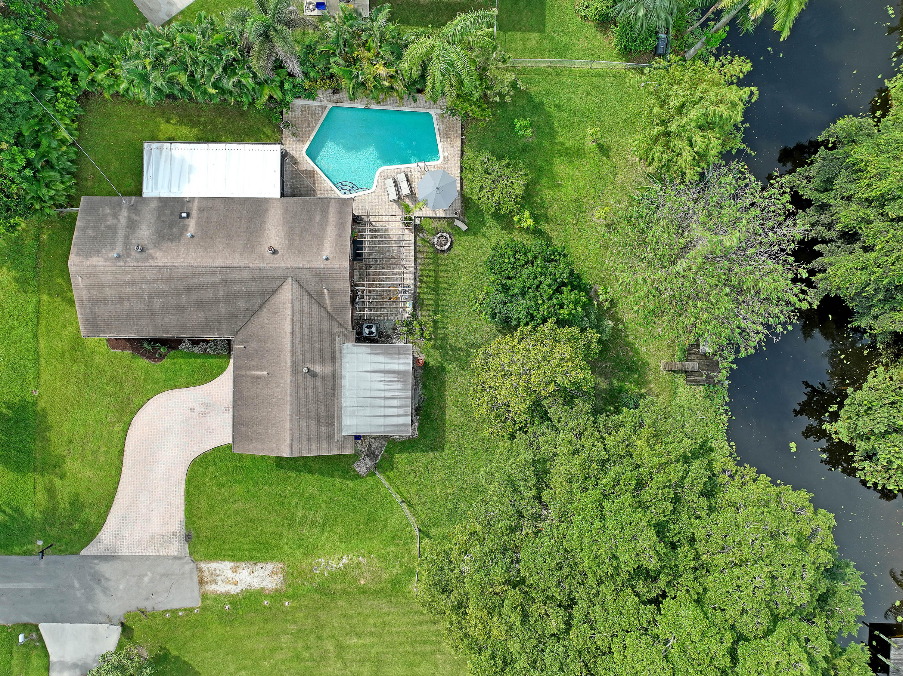 an aerial view of a house with a garden and trees