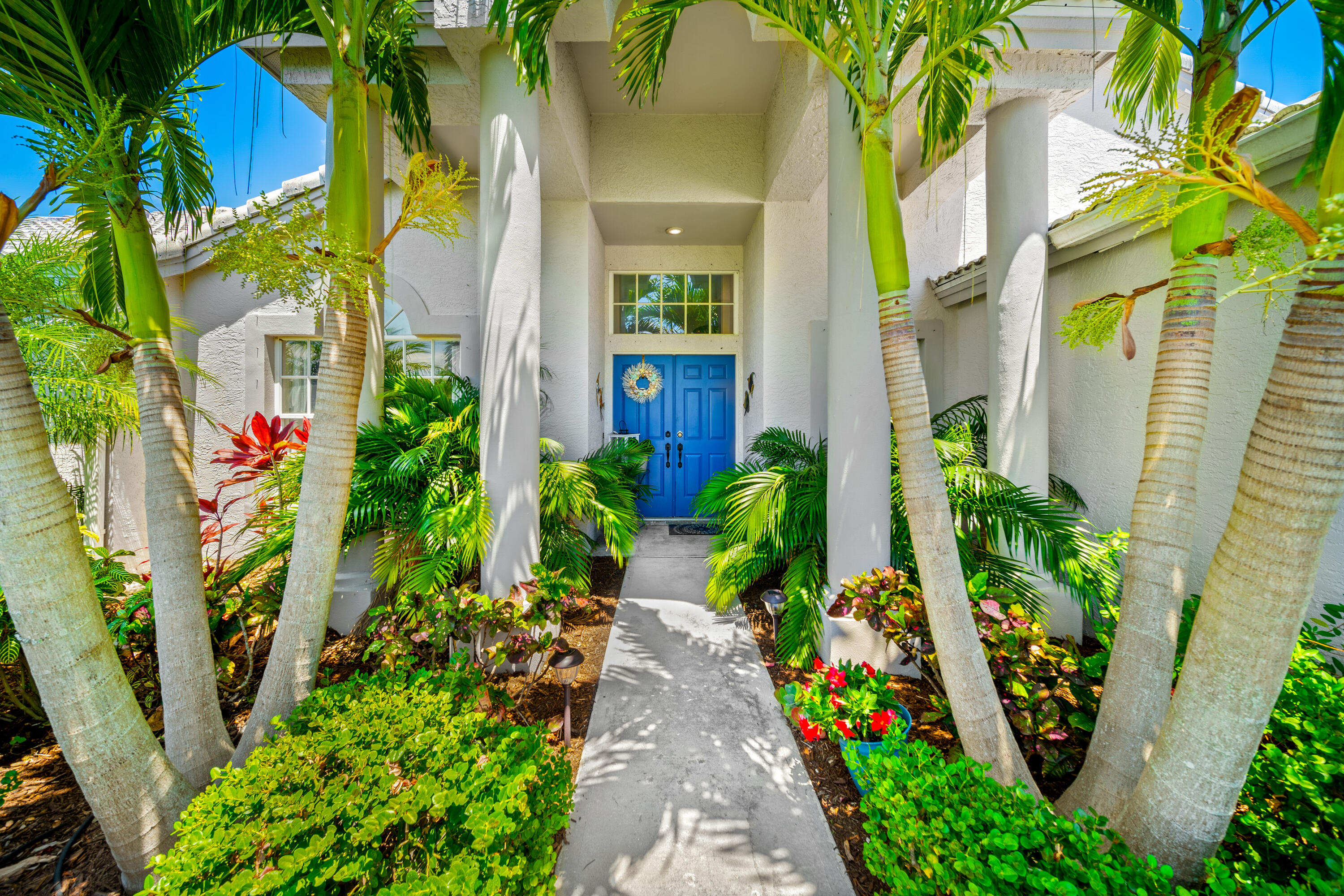 a view of multi story house with a flower garden