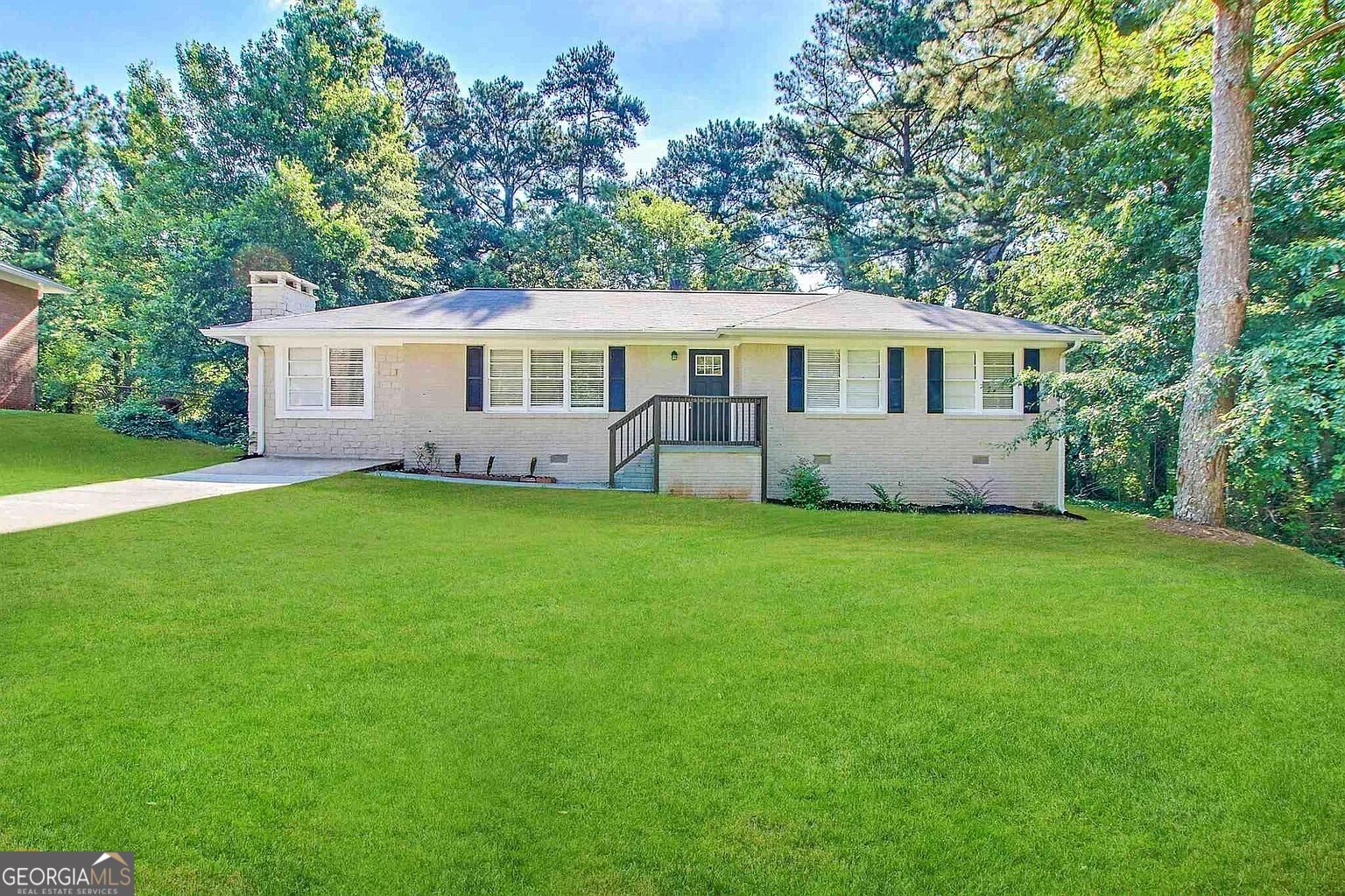 a front view of house with yard and green space