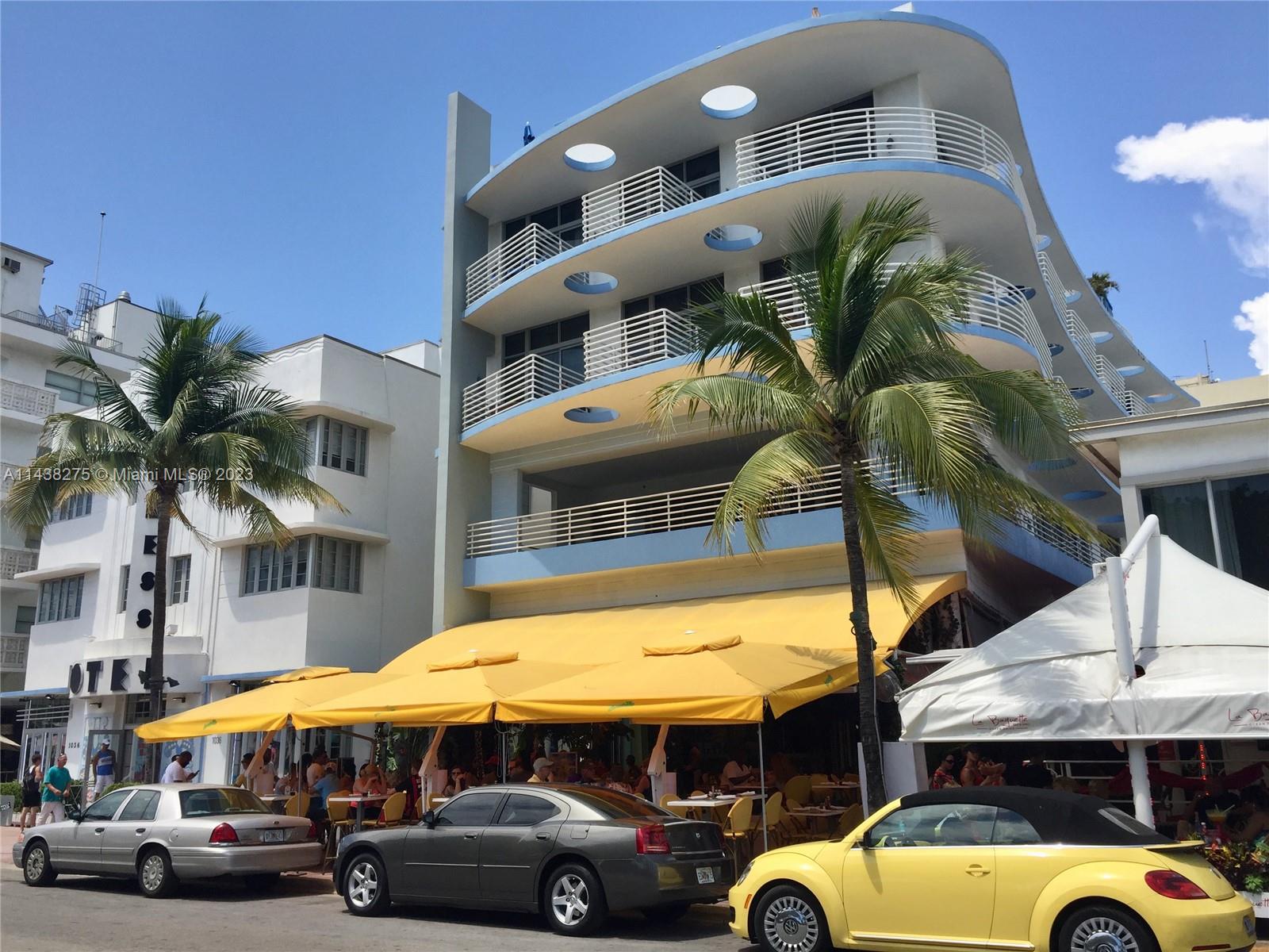 a view of a building with car parked