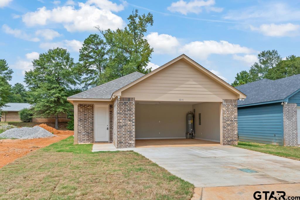 a view of a house with a yard and garage