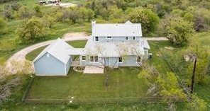 an aerial view of residential house with pool and yard