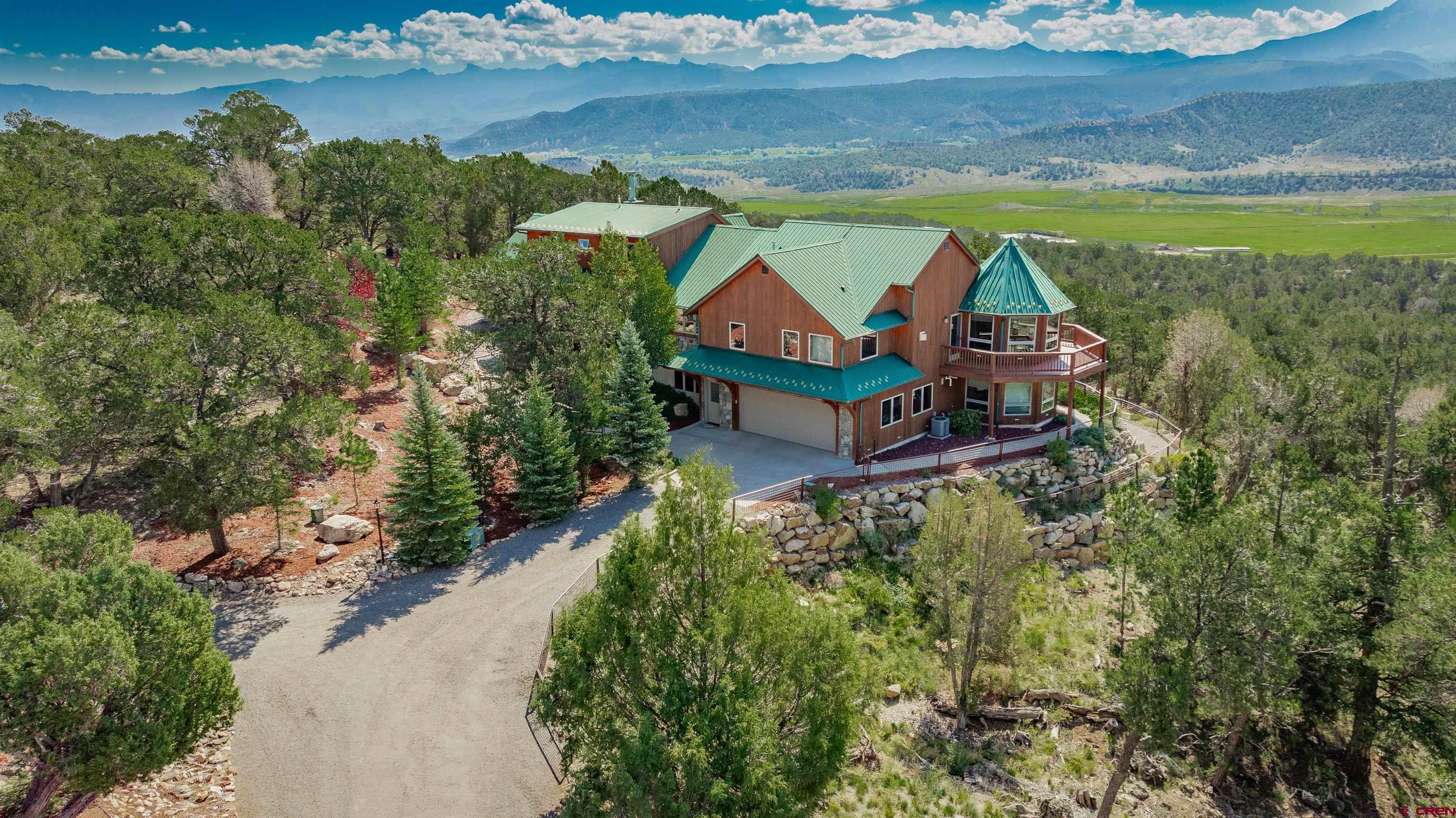 an aerial view of a house with a lake view