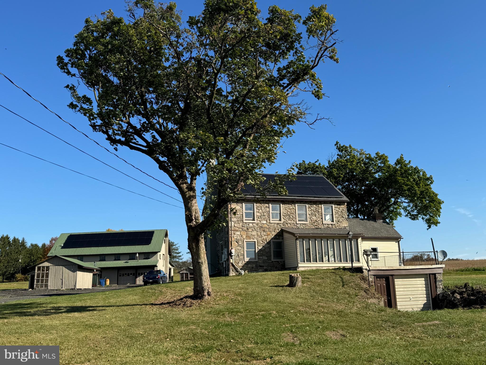 a view of a house with a yard deck and a slide