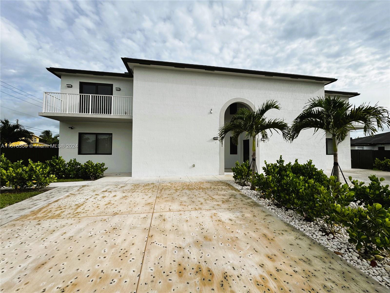 a front view of a house with parking space