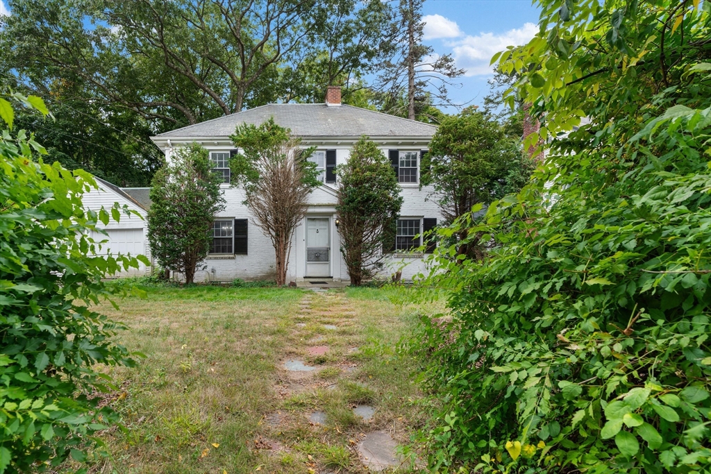 a view of a house with backyard and sitting area