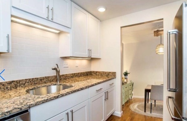 a kitchen with a sink and a refrigerator