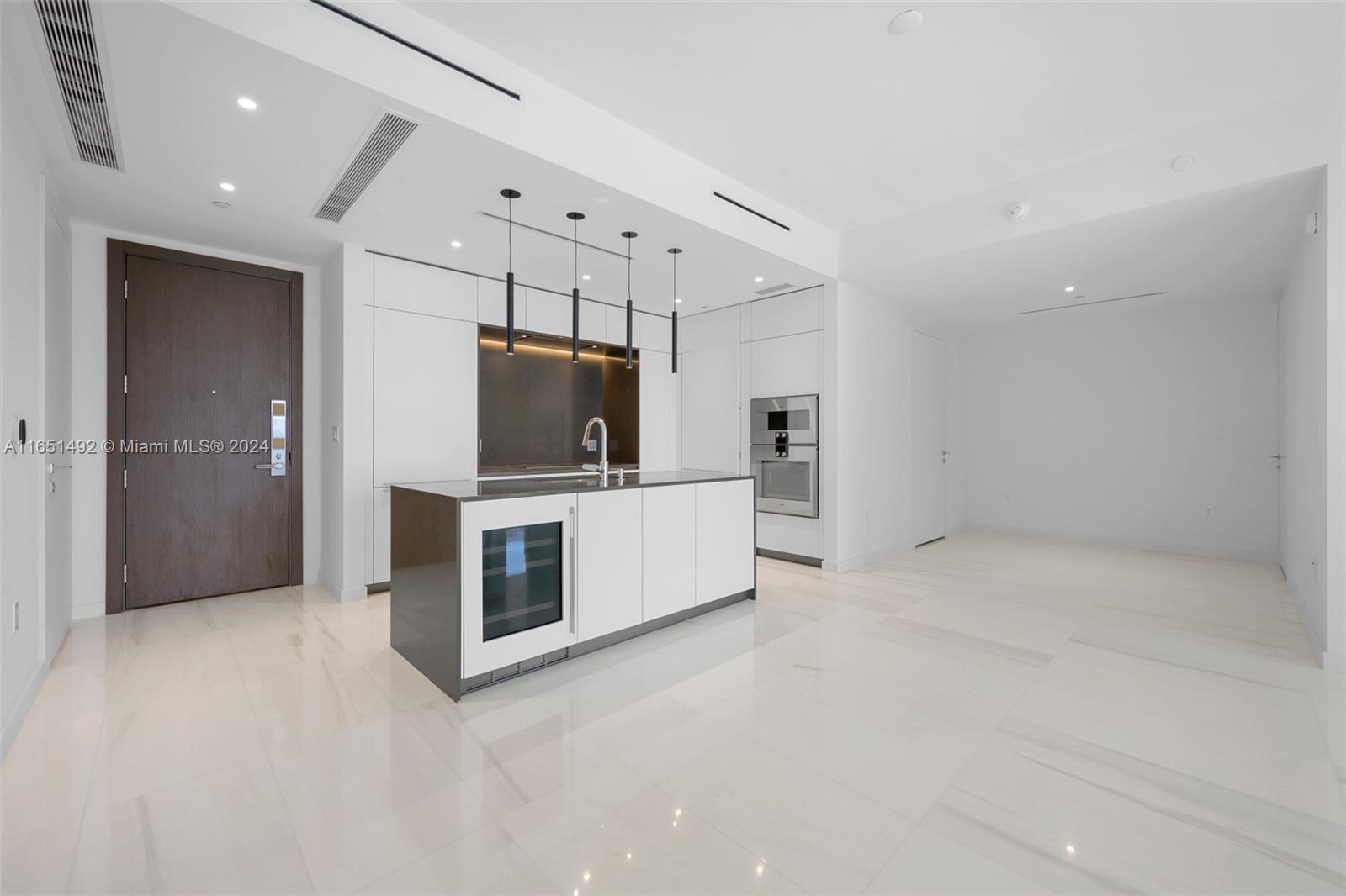 a view of a kitchen with a sink and a refrigerator