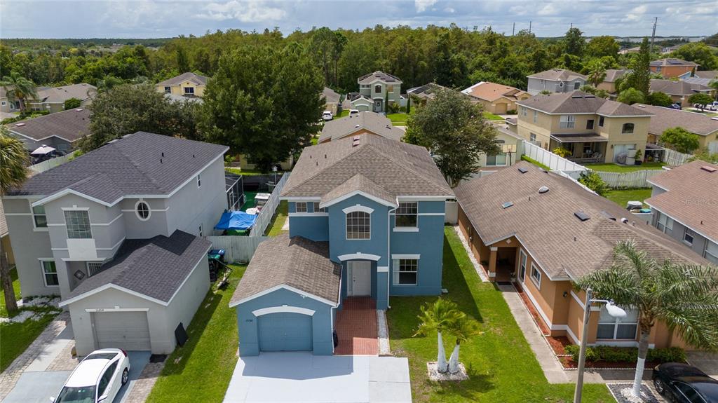 an aerial view of a house with a big yard