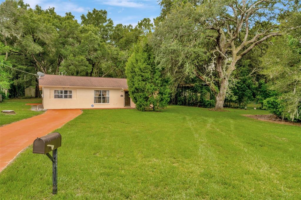 a view of house with backyard