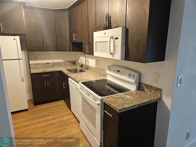 a kitchen with a stove sink and refrigerator