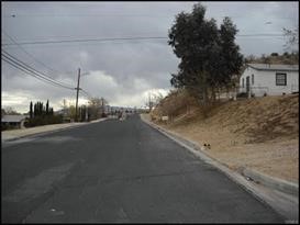 a view of a street with a cars parked on the road