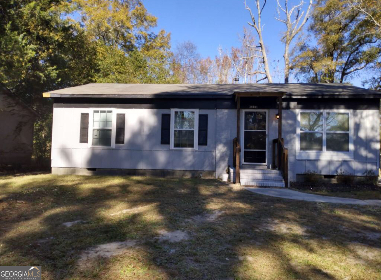 a view of house with backyard