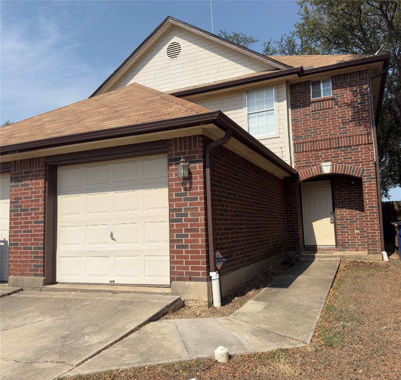 a side view of a house with a garage