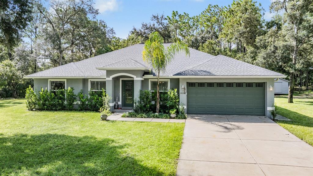 a front view of a house with a yard and garage