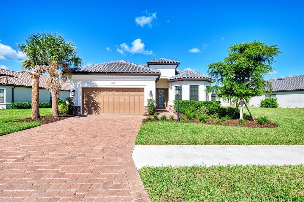 a front view of a house with a yard and garage