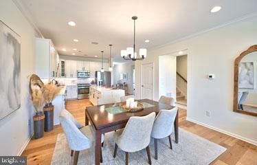 a dining room with furniture a chandelier and wooden floor