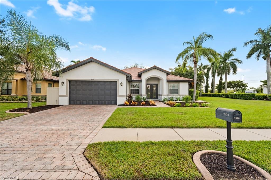 a front view of a house with a yard and garage