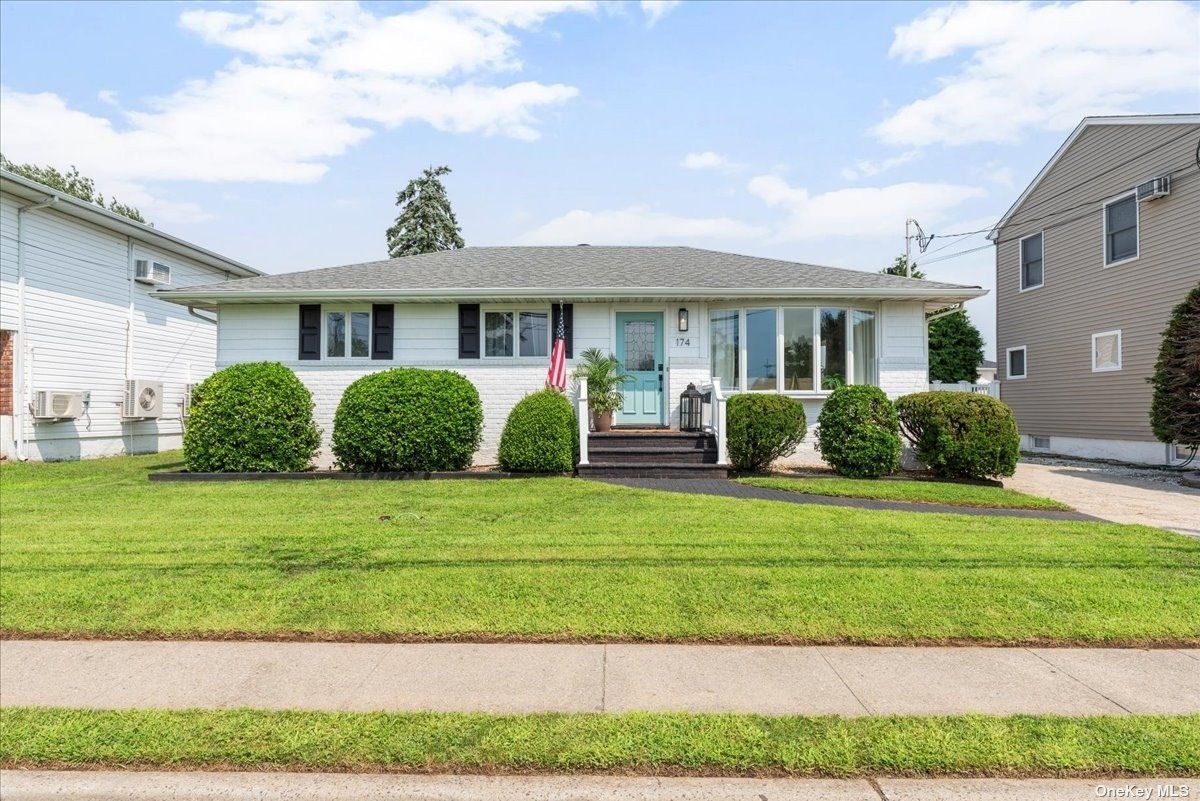 a front view of a house with a garden