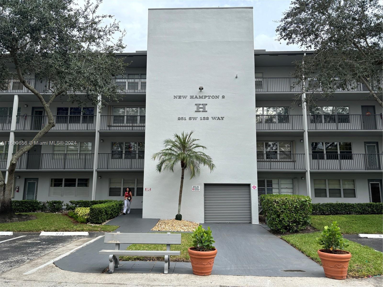 a front view of a building with garden