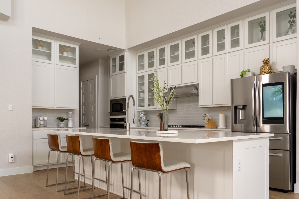 a kitchen with stainless steel appliances granite countertop a sink and cabinets