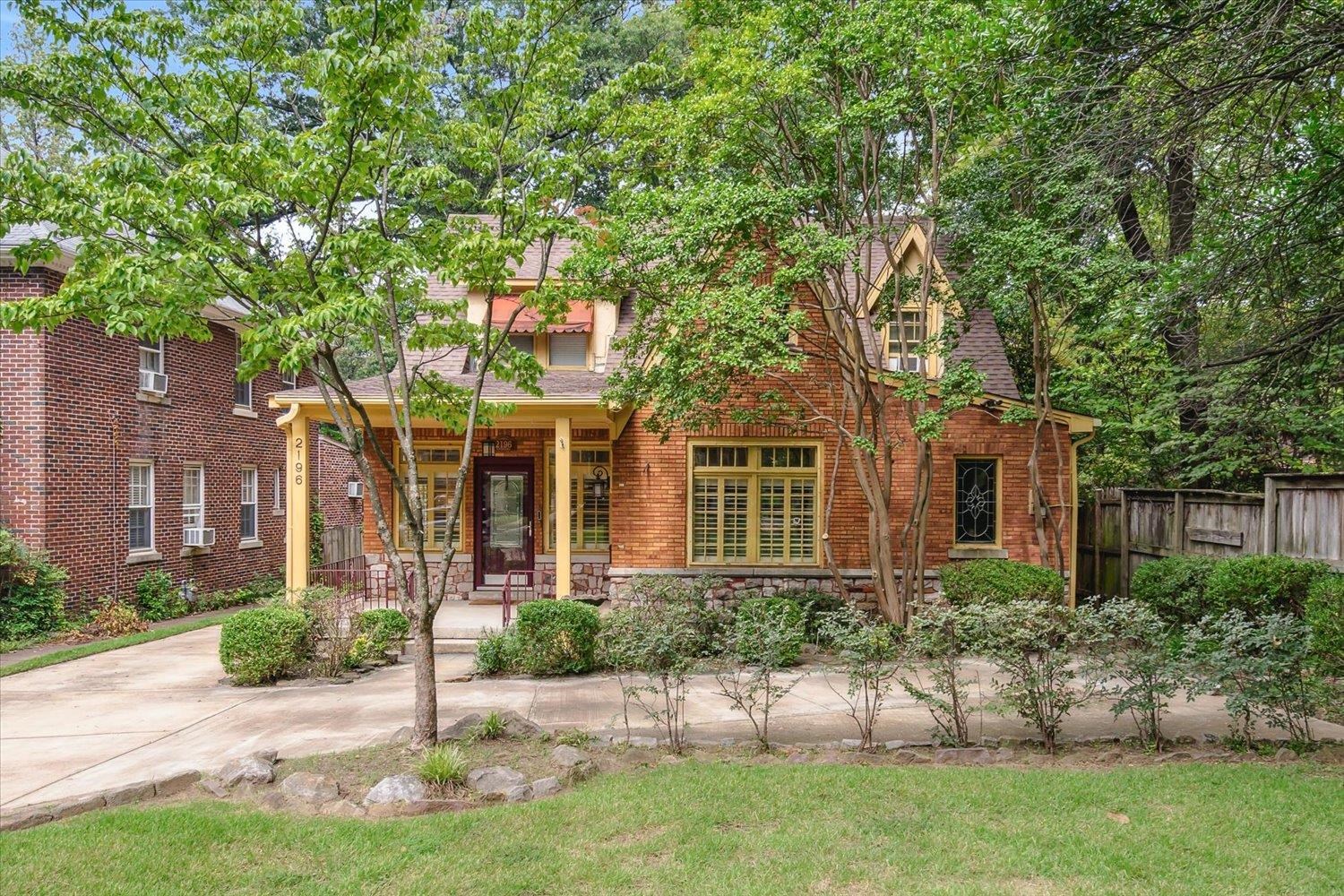 a front view of a house with a garden