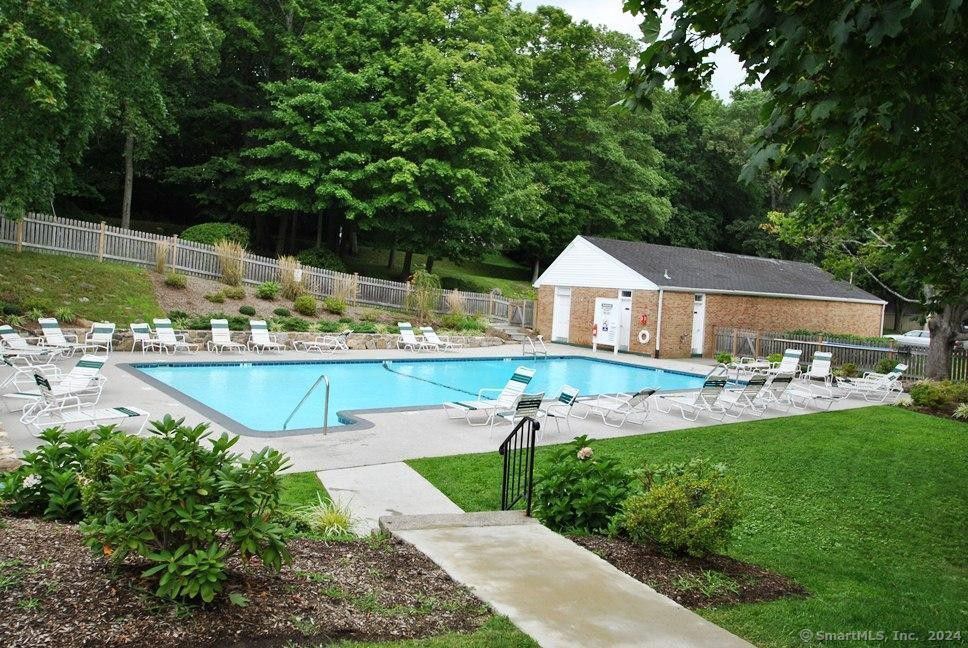 a view of a house with swimming pool and sitting area